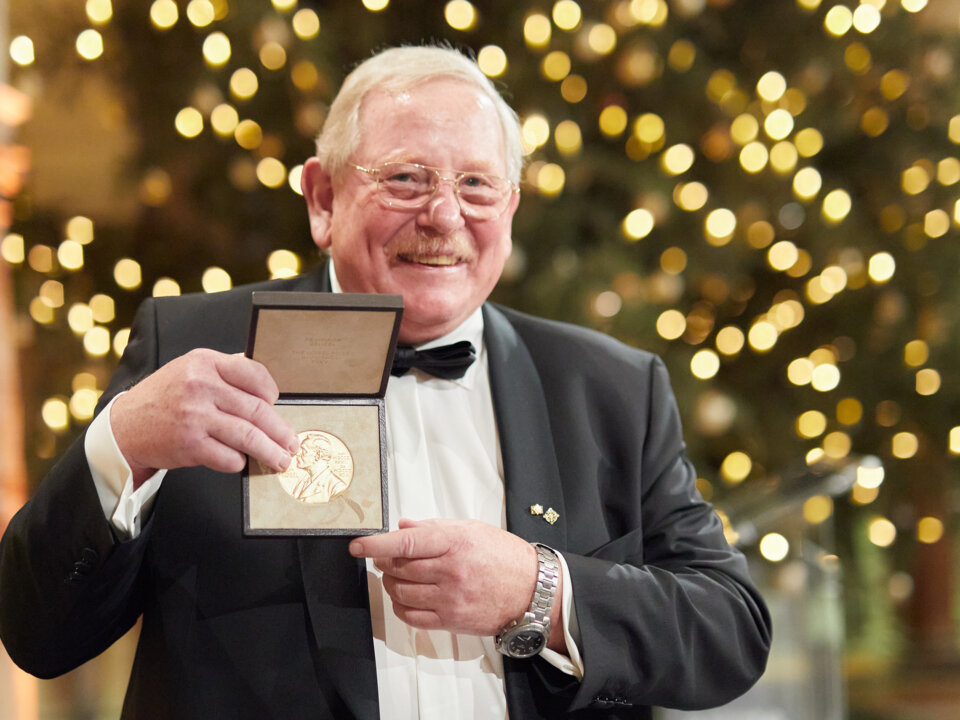 manbet手机版莱因哈德·根泽尔展示他的诺贝尔奖奖章。