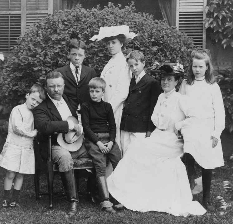 President and Mrs. Theodore Roosevelt seated on lawn, surrounded by their family