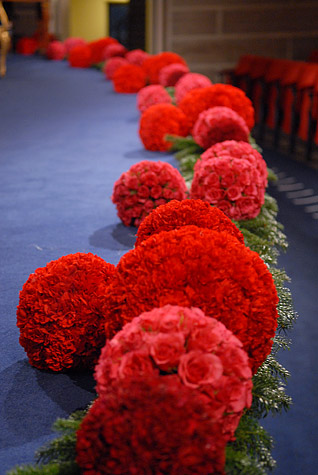 manbet手机版由不同深浅的红色康乃馨和玫瑰制成的插花
