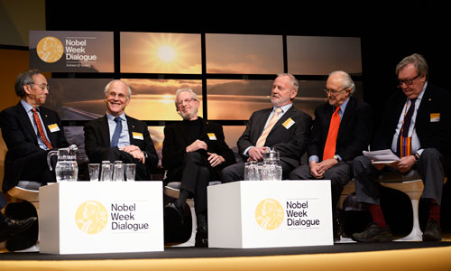 Six Nobel Laureates in a panel discussion at the 2013 Nobel Week Dialogue on 9 December 2013. From left: 1997 Physics Laureate Steven Chu, 2004 Physics Laureate David Gross, 2000 Chemistry Laureate Alan Heeger, 1988 Chemistry Laureate Hartmut Michel, 1995 Chemistry Laureate Mario Molina and 1984 Physics Laureate Carlo Rubbia